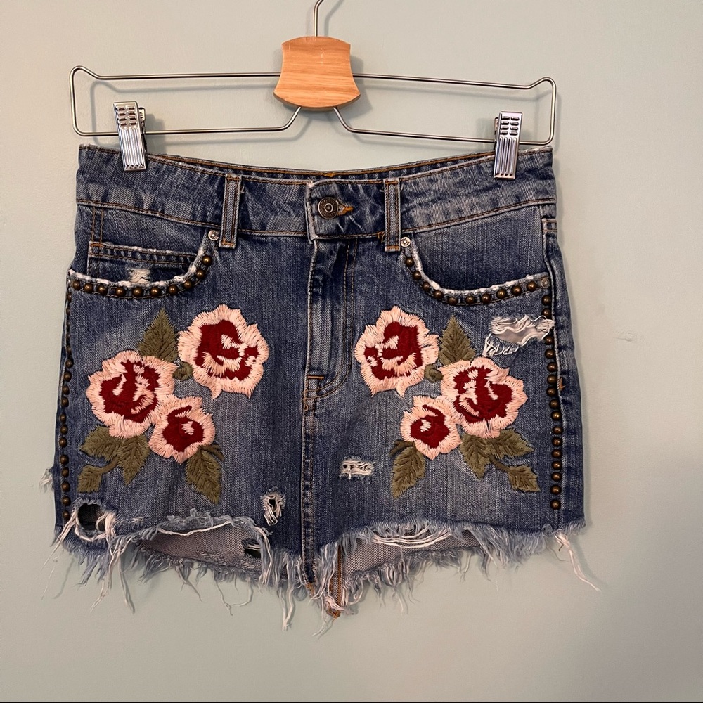 FREE PEOPLE Distressed denim skirt w/ floral embroidery and metal studs. Size 24